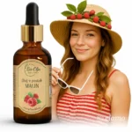 Naturalny olej z pestek malin Bio Olja – nierafinowany, idealny na lato, kobieta w słomkowym kapeluszu z malinami trzymająca okulary przeciwsłoneczne