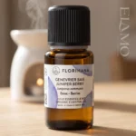 Butelka olejku jałowcowego Florihana na tle ceramicznego kominka aromaterapeutycznego do dyfuzji