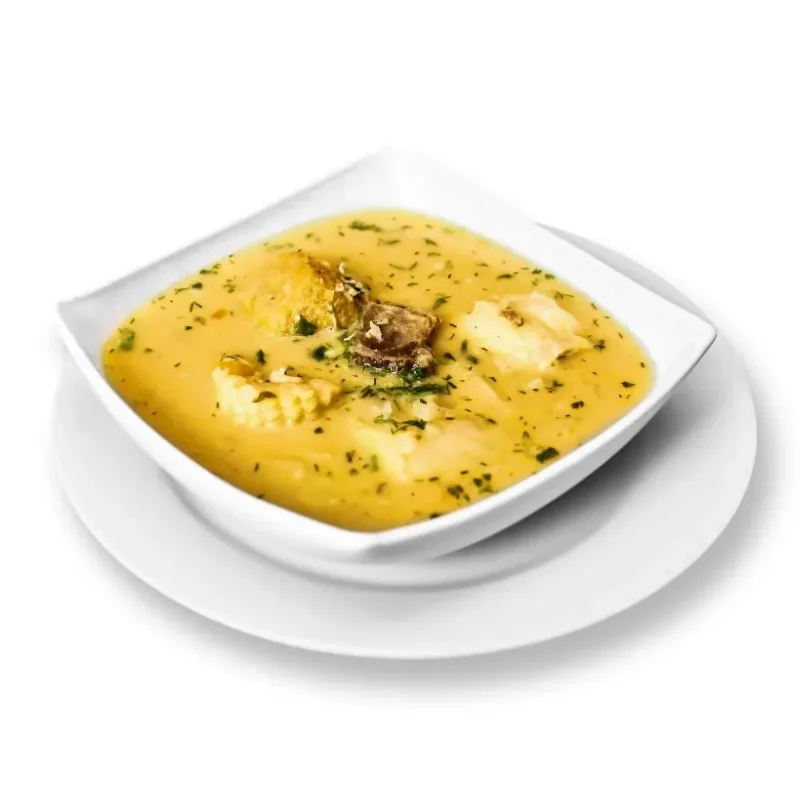 Tradycyjna peruwiańska zupa inchicapi podana na białym talerzu na izolowanym białym tle. Gęsta, złocista zupa z kurczakiem, zagęszczona nasionami Sacha Inchi, posypana świeżymi ziołami. Aromatyczne danie bogate w Omega-3, idealne dla kuchni zdrowotnej i południowoamerykańskich przepisów.