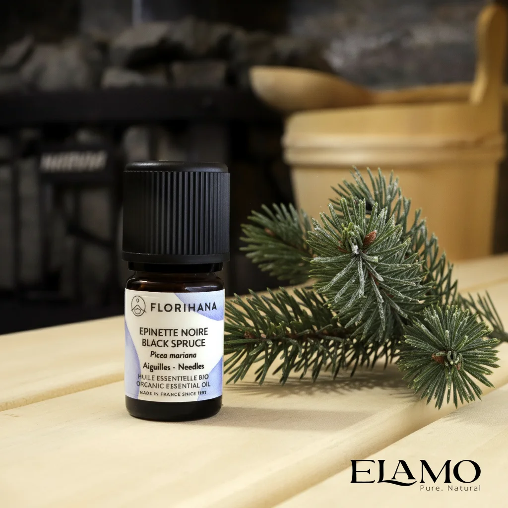 Olejek świerkowy czarny (Picea mariana) Florihana na ławie sauny; chłodny, balsamiczny aromat łagodny dla wrażliwych, polecany do łaźni parowej i delikatnych kompozycji.